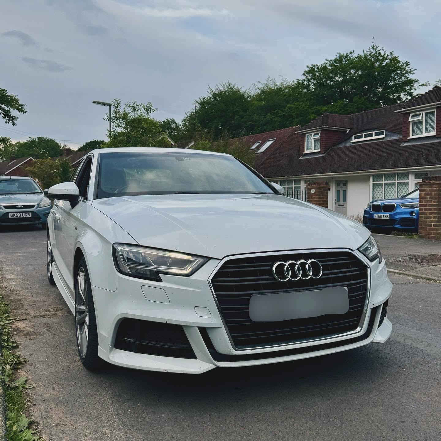 White Audi A3 S line on a residential street