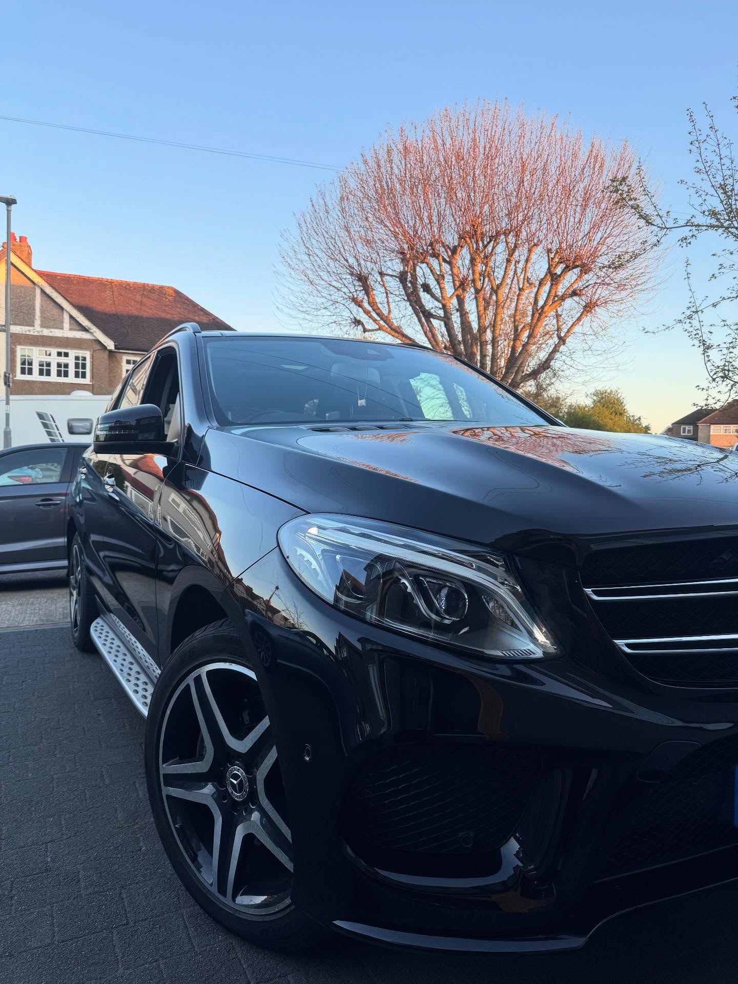 Black Mercedes GLE parked at sunset